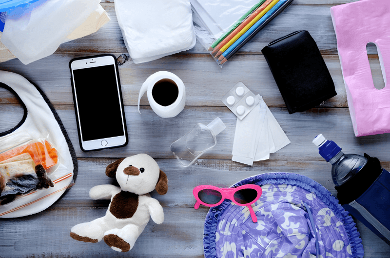 Must-have baby travel essentials for a stress-free journey, featuring diapers, wipes, toys,